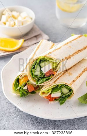 Wrap Sandwich, Roll With Fish Salmon, Vegetables And Cheese. Grey Background. Close Up.