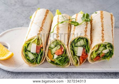 Wrap Sandwich, Roll With Fish Salmon, Vegetables And Cheese. Grey Background. Close Up.