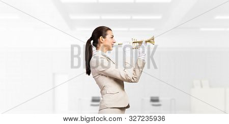 Business Woman Playing Trumpet Brass. Young Lady In White Business Suit And Gloves Posing With Music