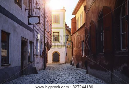 Narrow street of Old town. Czech Krumlov. Czech Republic. Walls of medieval houses and road of paving stones.