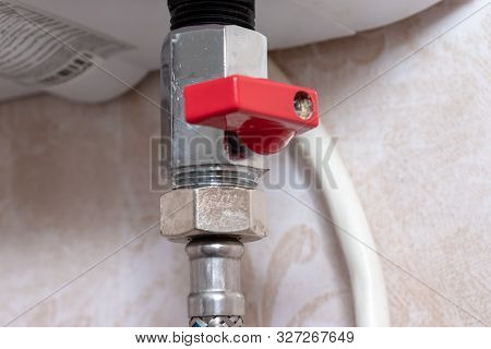 Red Metal Sanitary Valve That Provides Hot Water Supply From A Water Heater, Boiler