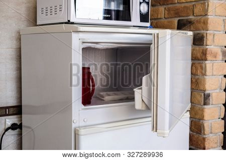 Brest, Belarus - August, 2, 2019: image of a refrigerator and a microwave oven in a hotel kitchen in Brest