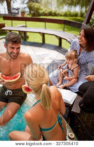 Young man with women and kid on swiming pool 