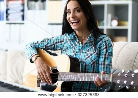 Portrait Of Wonderful Female Studying New Melody And Playing In Studio. Beautiful Lady Wearing Check