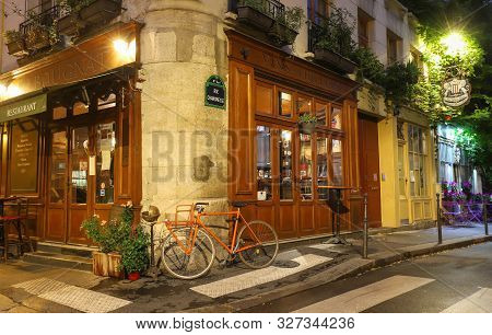 Paris, France-october 08, 2019: The Traditional French Cafe Au Bougnat At Night . It Located Near No