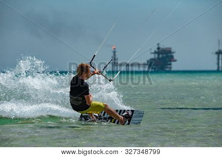Kitesurfing on the waves of the sea in Mui Ne beach, Phan Thiet, Binh Thuan, Vietnam. Kitesurfing, Kiteboarding action photos Kitesurfer In action