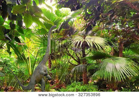 Big Dinosaur Long-neck. Close-up Against The Backdrop Of A Jungle