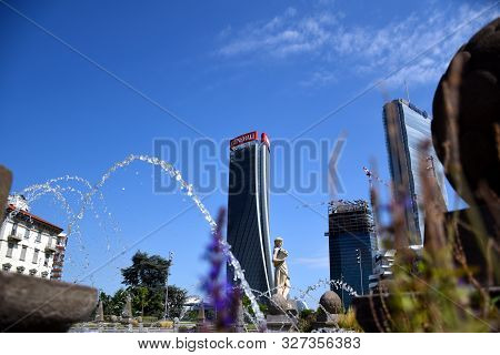 Milano, Italy, 14.07.2019: Fountain Of The Four Seasons At Piazzale Giulio Cesare With The Three Tow