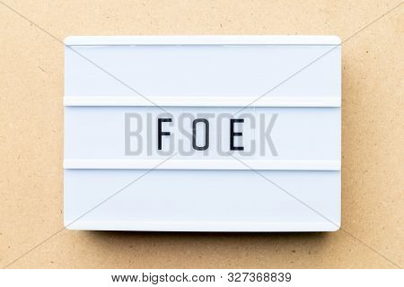 White Lightbox With Word Foe On Wood Background