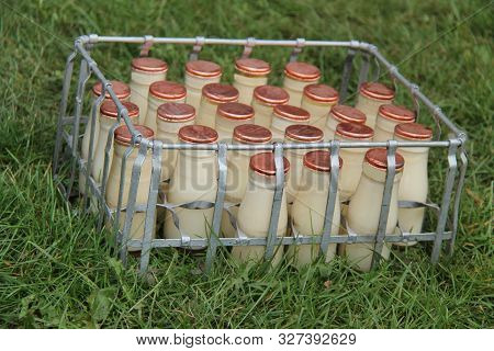 A Crate Of Vintage Small Glass Milk Bottles.