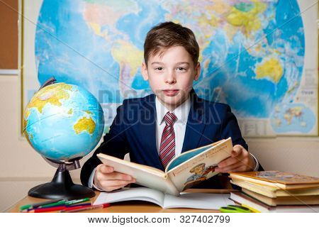 Russia, Moscow, March 2019, School Photography. A Schoolboy In Uniform At A Geography Lesson. In The