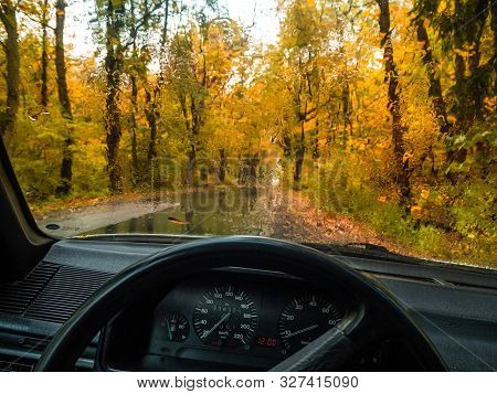 Road In The Autumn Forest In Rain. Asphalt  Road In Overcast Rainy Day. Roadway With Reflection And 