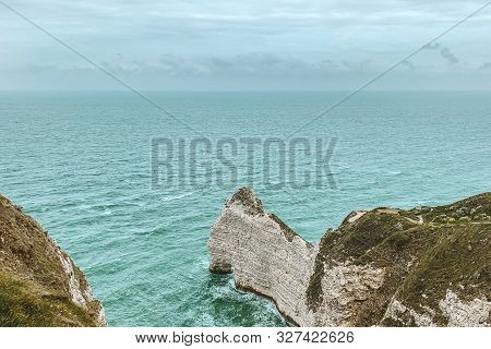 West Coast Of France. Étretat. Great View From A Great Height. The Sea Beats Against Rocks And Stone