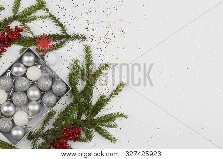 Christmas Background. Christmas Decorations In Box With Christmas Tree Branches On White Background 