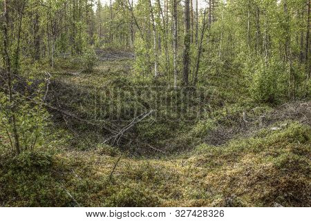 Remains Of An Ancient Trapping Pit Near At The Stream Skelleftalven In Vasterbotten, Sweden