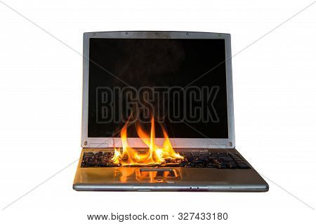 Burning Laptop And Keyboard, Equipment Fire Due To Faulty Battery And Wiring. On A White Background,