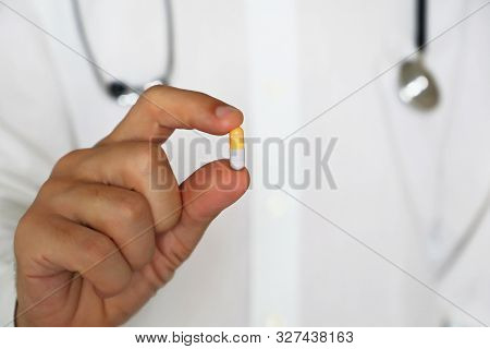 Doctor Holding Pill, Male Hand With Medication In Capsule Close-up. Man With Tablet, Concept Of Phar