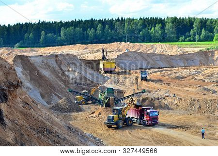 Wheel Front-end Loader Loads Sand Into A Dump Truck. Heavy Machinery In The Mining Quarry, Excavator