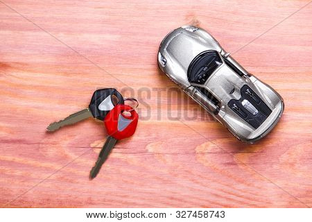 Car Loands And Credit Concepts. Car Symbol Along With Bunch Of Keys Against Vintage Wooden Backgroun