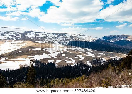 Lago Naki Spring Plateau With Snowy Hills, Blue Sky And Clouds