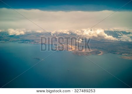 Aerial View Of The Desertic Surroundings Of The Titikaka Lake And The Tiny Houses Around It With Clo