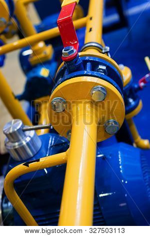 Gas Station. Many Diverse Pipes Connected By Flanges. Flange Bolt Connection. The Pipes Are Painted 