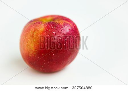 One Red Apple With The Water Drops On The White Background