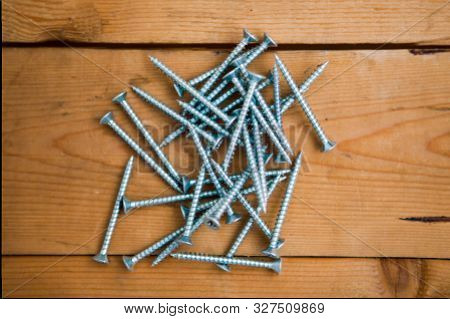 Set Of Bolts (metalware) On The Wooden Background