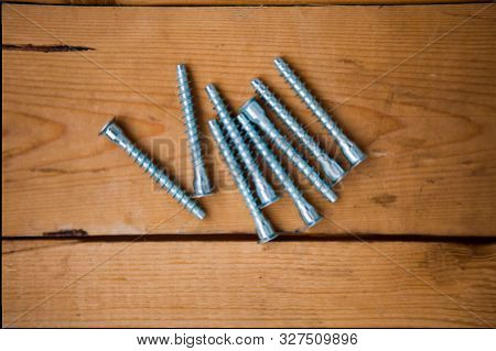 Set Of Bolts (metalware) On The Wooden Background