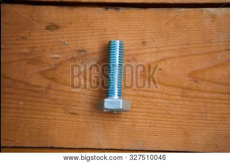 Metalware (bolt, Screw) On The Wooden Background