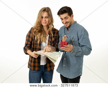 Young Couple Searching For Directions Using A Map And Gps On Mobile Phone.