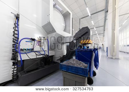 Inside Of Factory Unit With New Modern Computerized Equipment And Mechanisms And Box With Swarf. Pho