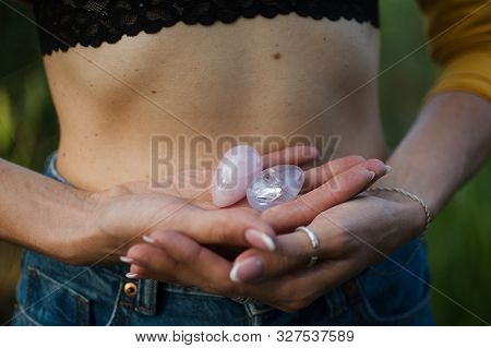 Female Hands Holding Two Yoni Eggs For Vumfit, Imbuilding Or Meditation Are Made From Pink Quartz An