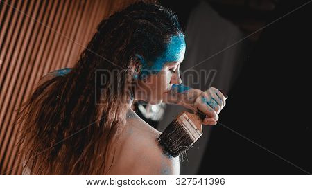 Portrait Of Beautiful Girl With Blue Facial Bodyart With Sequins. The Artist Draws Body Art On Herse