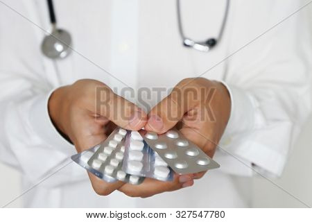 Doctor Giving Pills, Physician Holding In Hands Medication In Blister Packs. Concept Of Dose Of Drug