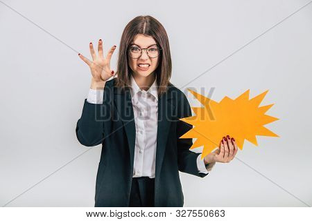 Excited Young Business Woman Holding An Empty Sparkle-like Speech Bubble, Setting Her Teeth, Showing