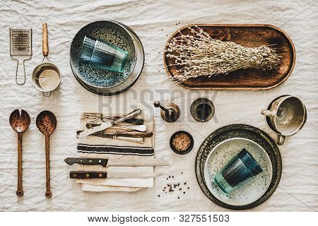 Various Kitchen Utensils And Tablewear Over Linen Tablecloth