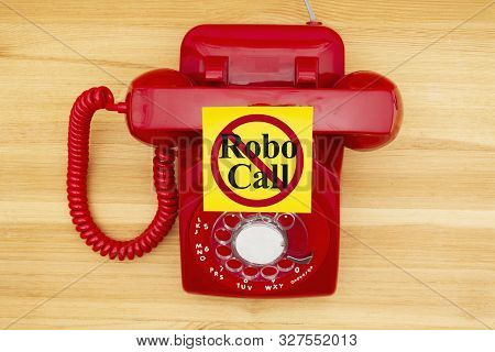 No Robo Call Message On A Sticky Note On A Red Old Retro Rotary Landline Phone On A Wood Desk