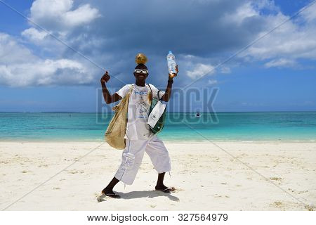Kendwa, Zanzibar - October 3, 2019: Local Man, Coconut And Water Seller On Kendwa Beach. Tanzania, A