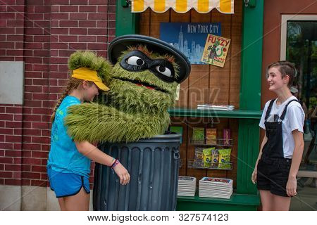 Orlando, Florida. July 30, 2019. Oscar The Grouch With Nice Girls In Sesame Street Party Parade At S