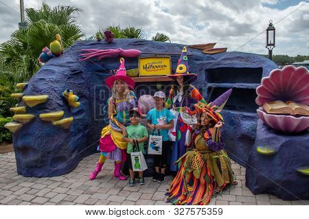 Orlando, Florida. September 21, 2019. Colorful Witches Interacting With Childs At Seaworld 149