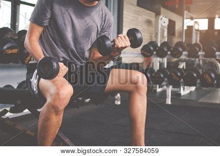 Closeup Of A Thin Man Doing Exercises With Dumbbell. Fitness Muscular Body. Fitness Concept