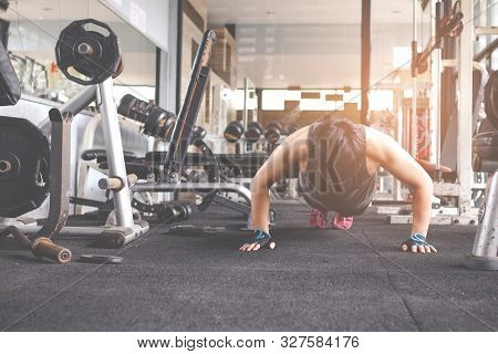 Sport Man Doing Push Ups Exercise In Gym. Workout Concept. Fitness Concept