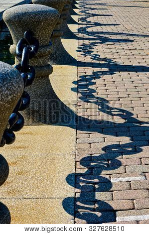 Heavy Iron Link Fence Reflecting On Brick And Tiled Walkway Near Lake Erie In Cleveland