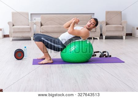 Young man training and exercising at home