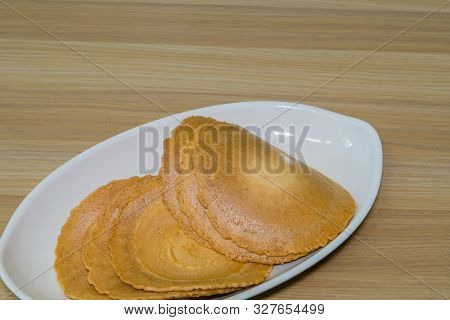 Closeup Of Crispy Traditional Korean Rice Cookies On White Serving Dish.