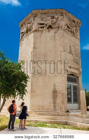 Athens, Greece - April, 2018: Young Couple Of Tourists Visiting The Tower Of The Winds Or The Horolo