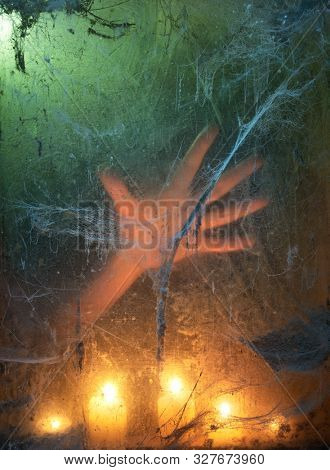 Halloween Party Background. Creepy candlelight in a dark room with an old web