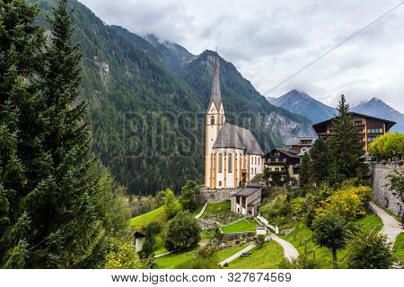 Gothic church of St. Vincenzo. Heiligenblut - beautiful village in the Austrian Alps. The beginning of the road Grossglocknerstrasse. The concept of ecological, historical and phototourism