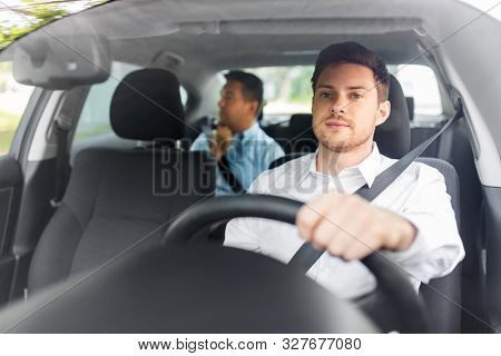 transport, vehicle and people concept - male driver driving car with passenger